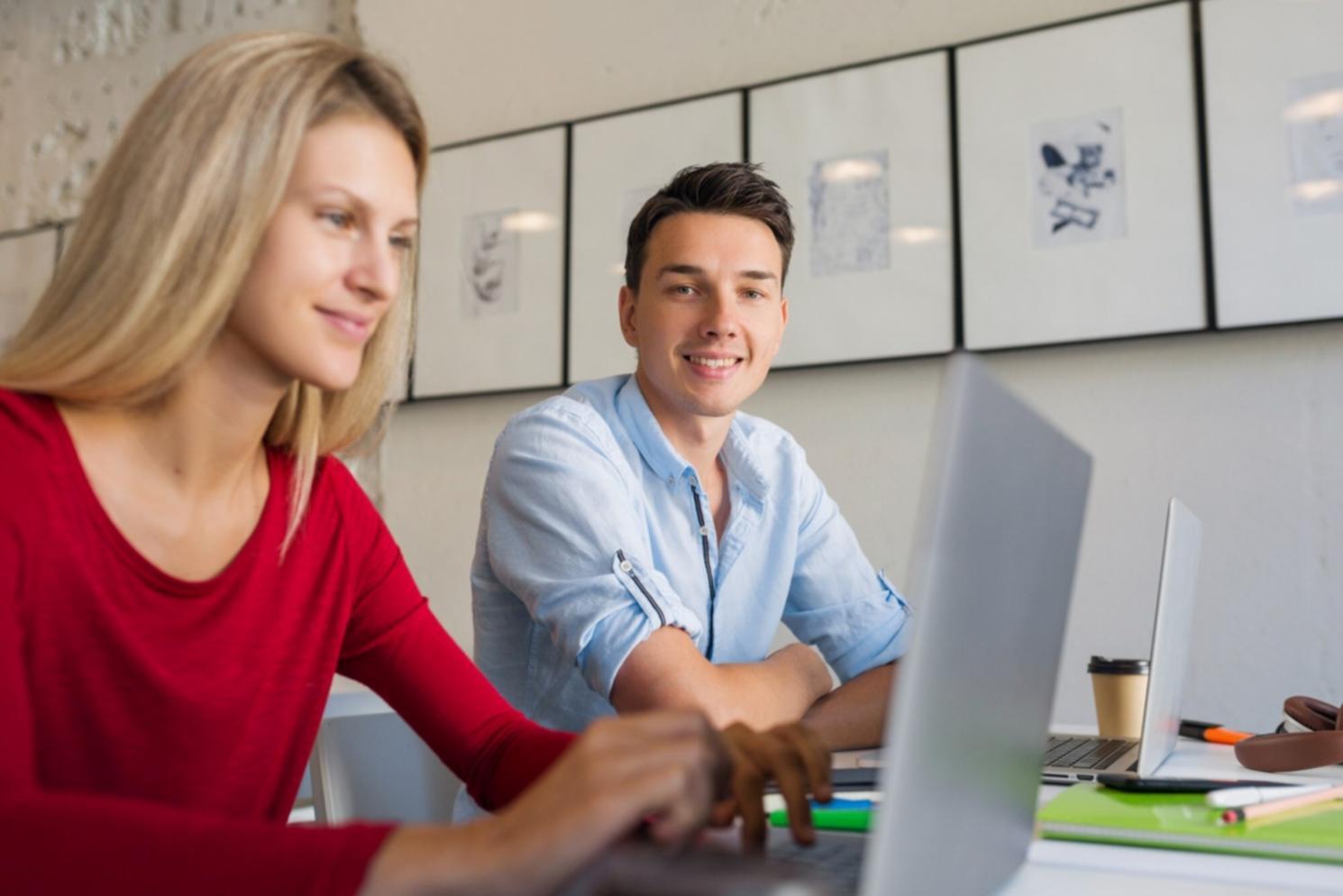 Students collaborating on video editing and campaign planning in modern classroom setting